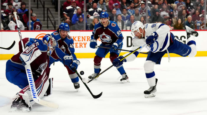 Feb 10, 2022; Denver, Colorado, USA; Tampa Bay Lightning center Steven Stamkos (91) shoots the puck on Colorado Avalanche goaltender Darcy Kuemper (35) and defenseman Samuel Girard (49) in the third period at Ball Arena.